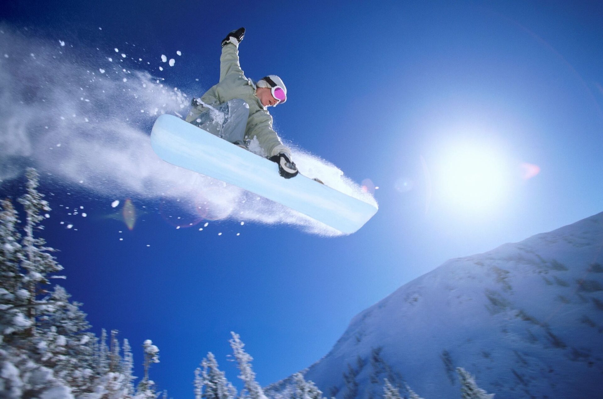 A person on a snowboard in the air.