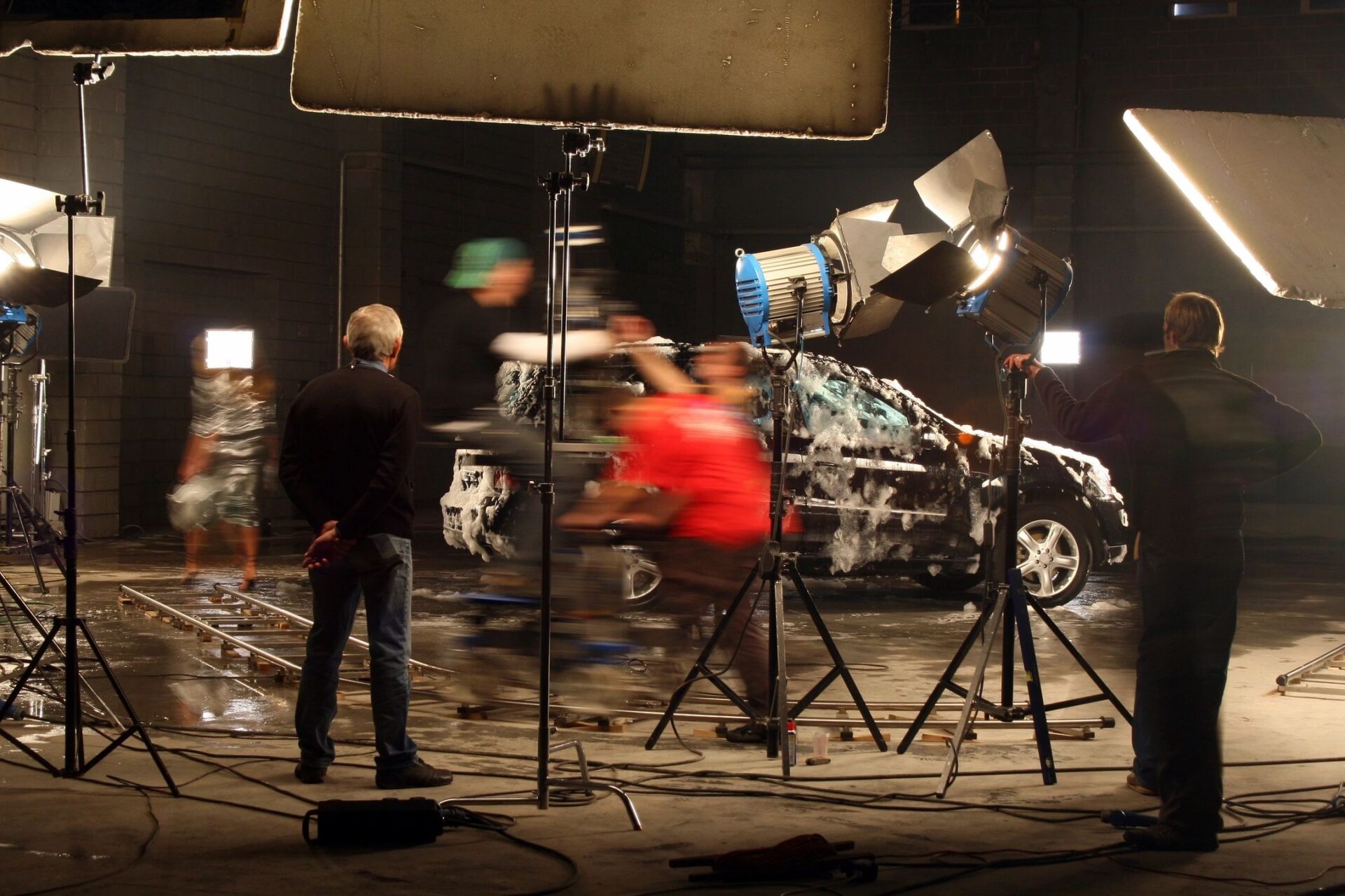 A man is filming an action scene in the dark.