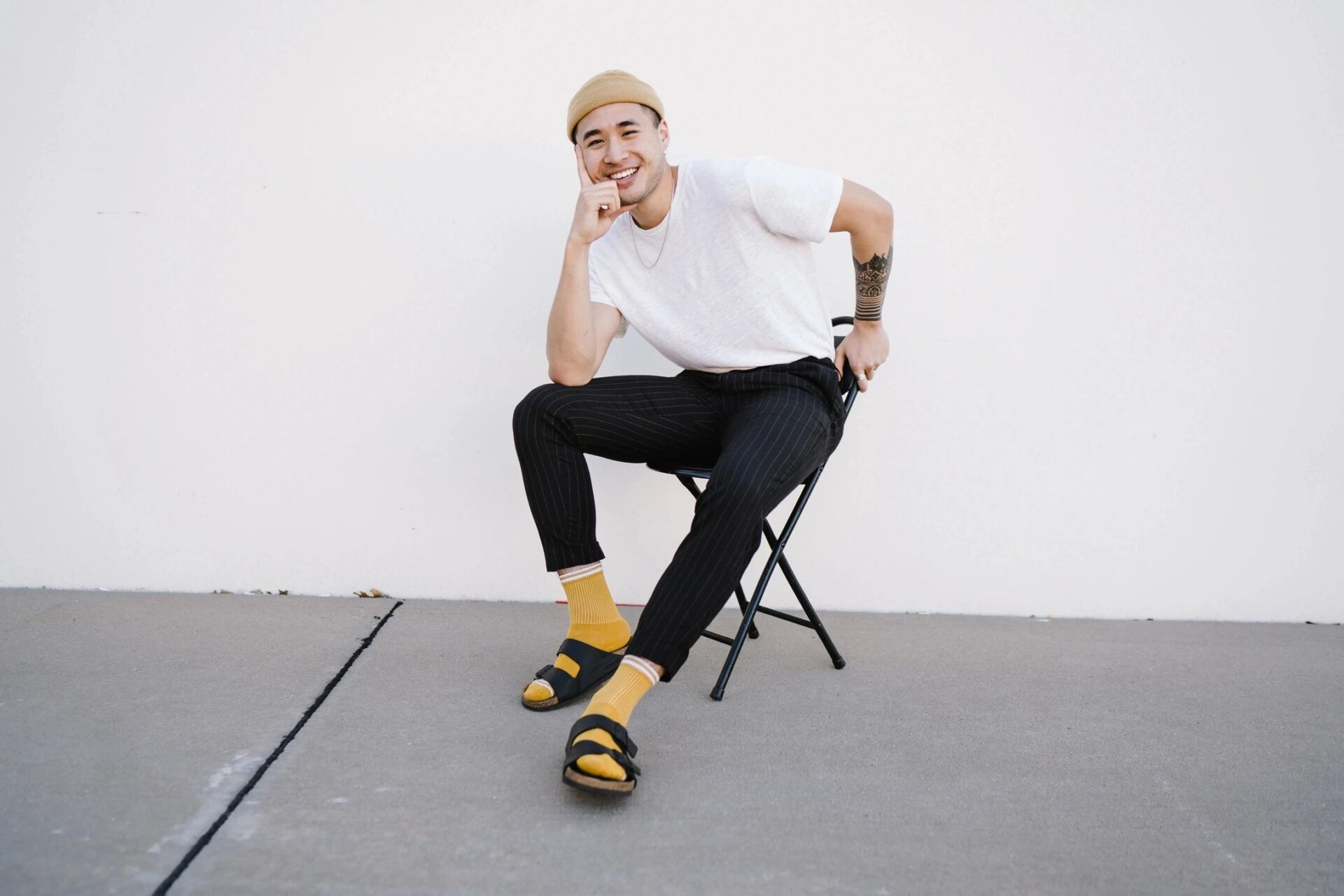 A man sitting on top of a chair wearing socks.