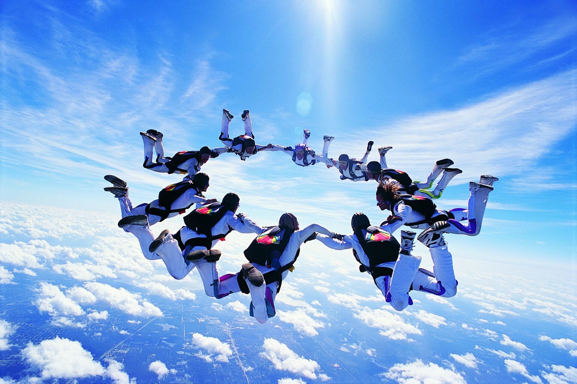 A group of people in the air with parachutes.